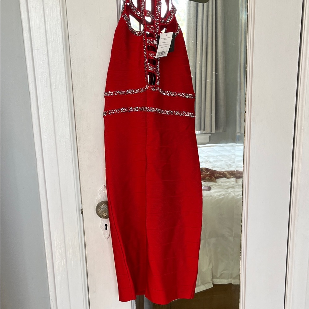 Bebe Red mini/Midi dress with Patterned Accents. Red and silver crystals.